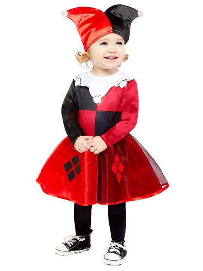 Front view of a toddler wearing a red and black Harley Quinn costume dress with diamond prints in a brightly lit play area.