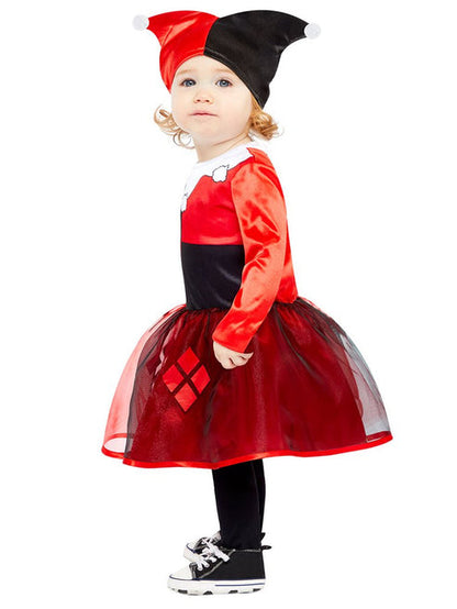 Front view of a toddler wearing a red and black Harley Quinn costume dress with diamond prints in a brightly lit play area.
