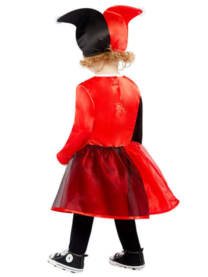 Front view of a toddler wearing a red and black Harley Quinn costume dress with diamond prints in a brightly lit play area.
