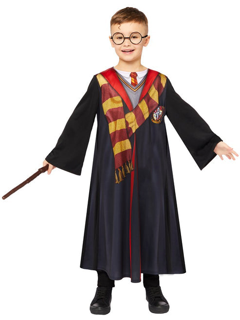 Front view of child wearing deluxe Harry Potter black robe with embroidered house crest and red satin hood lining in studio lighting.