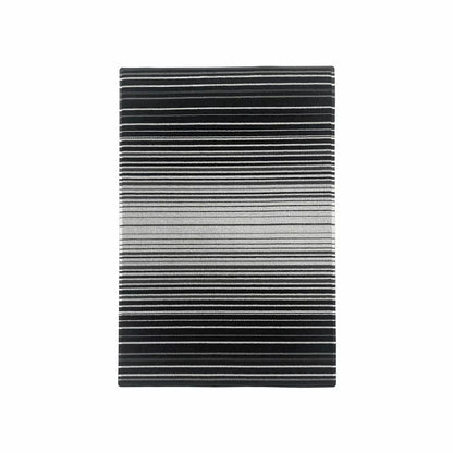 Top-down view of the black Korhani Loop Scraper Utility Mat showing its textured vinyl loop-scraper surface and low-profile edge on a modern wooden hallway floor.