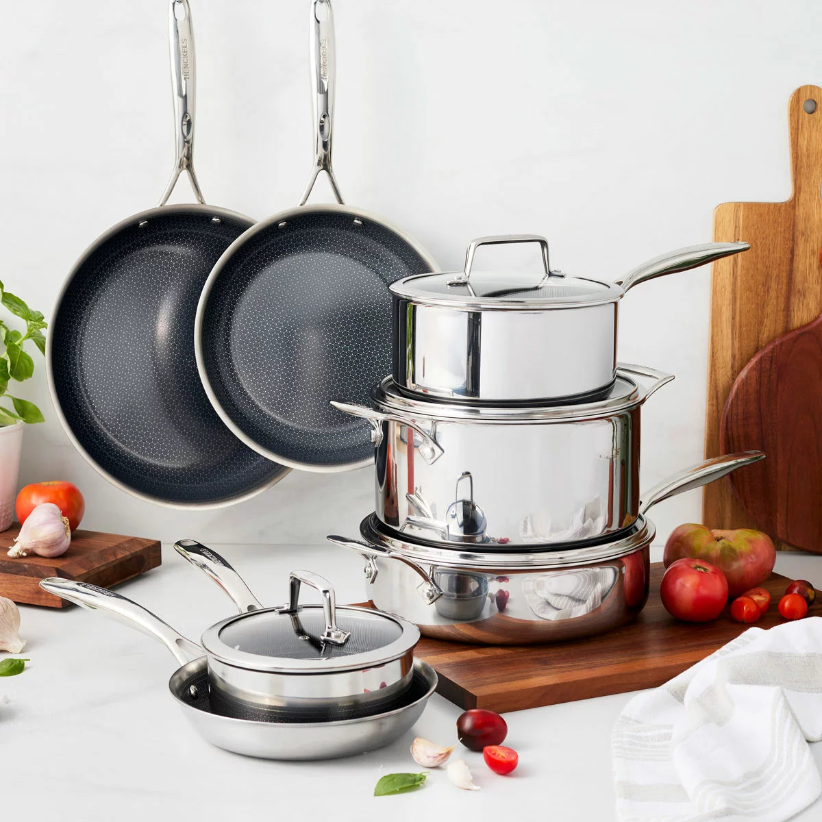 Henckels Paradigm 11-piece stainless steel cookware set with pots, pans, and lids for even heat distribution and everyday cooking