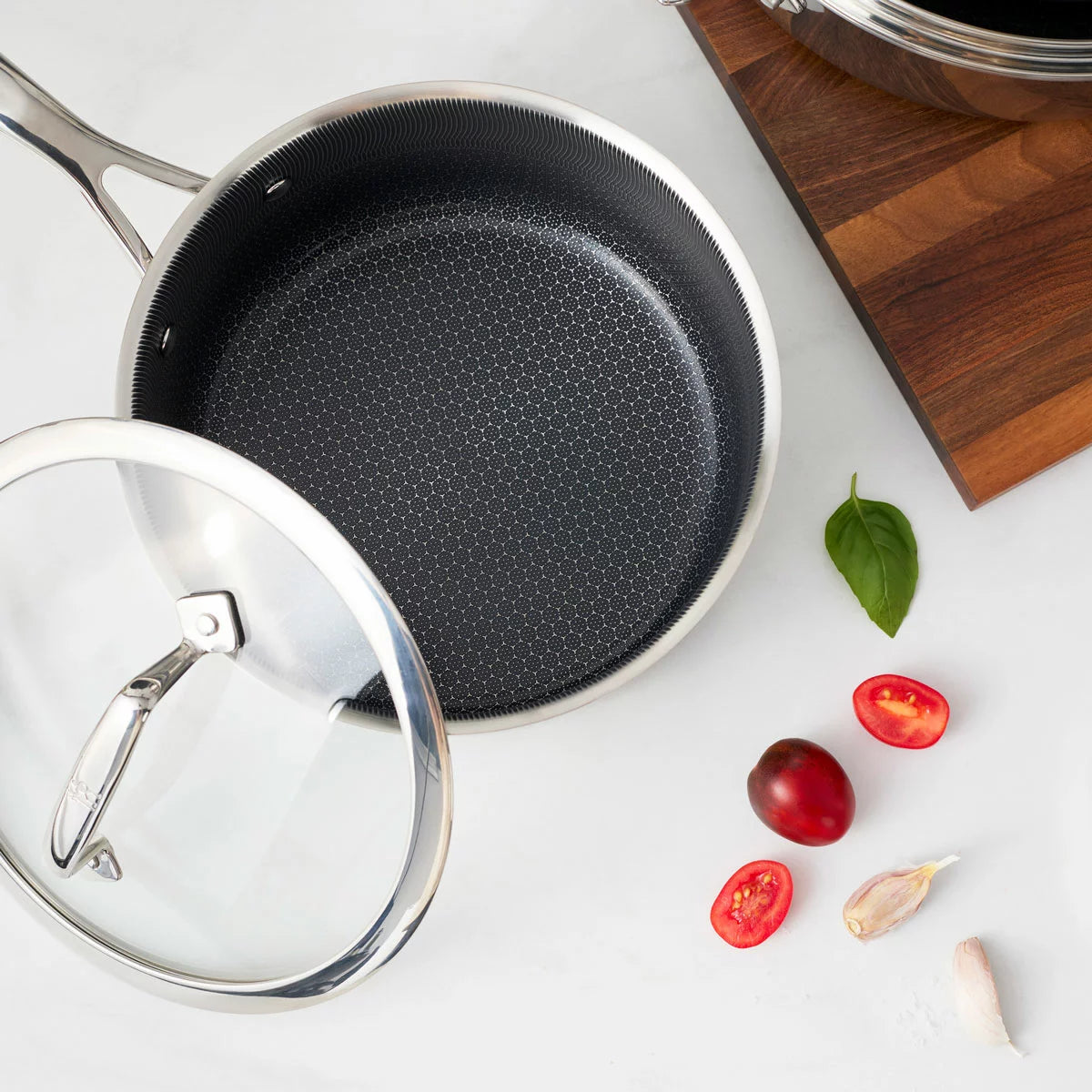 Henckels Paradigm 11-piece stainless steel cookware set with pots, pans, and lids for even heat distribution and everyday cooking