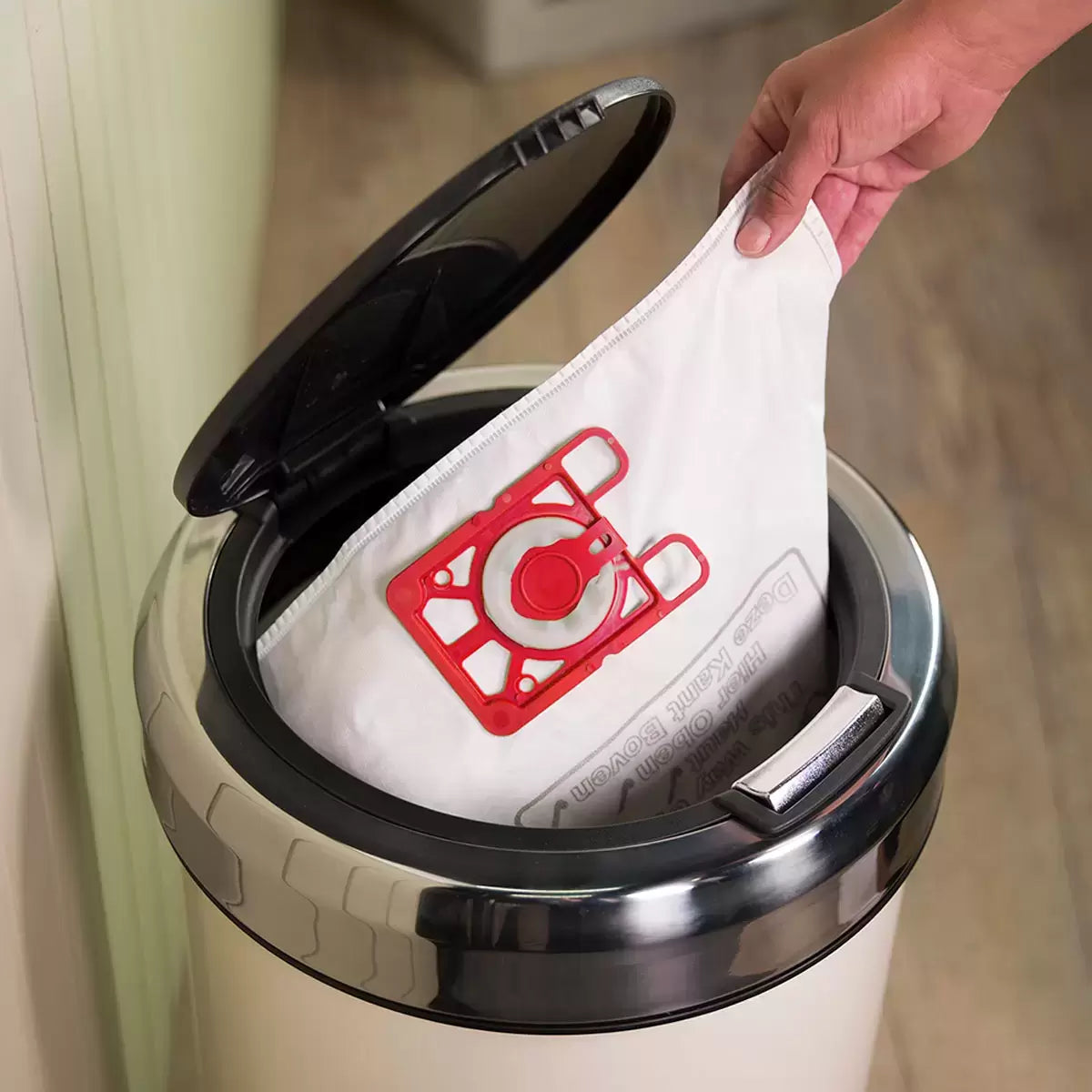 Red and black Henry Micro corded vacuum cleaner HVR.200M-11 with face logo, stainless steel wand, and attached EcoBrush tool set up on a hard floor surface.