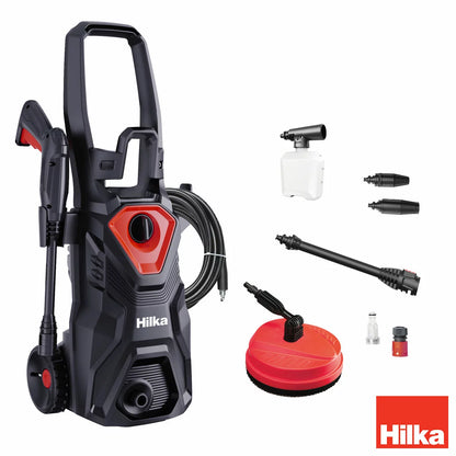 A compact Hilka 1600W pressure washer shown with its patio cleaner attachment, high-pressure nozzle, and foam bottle, set against a clean residential driveway.