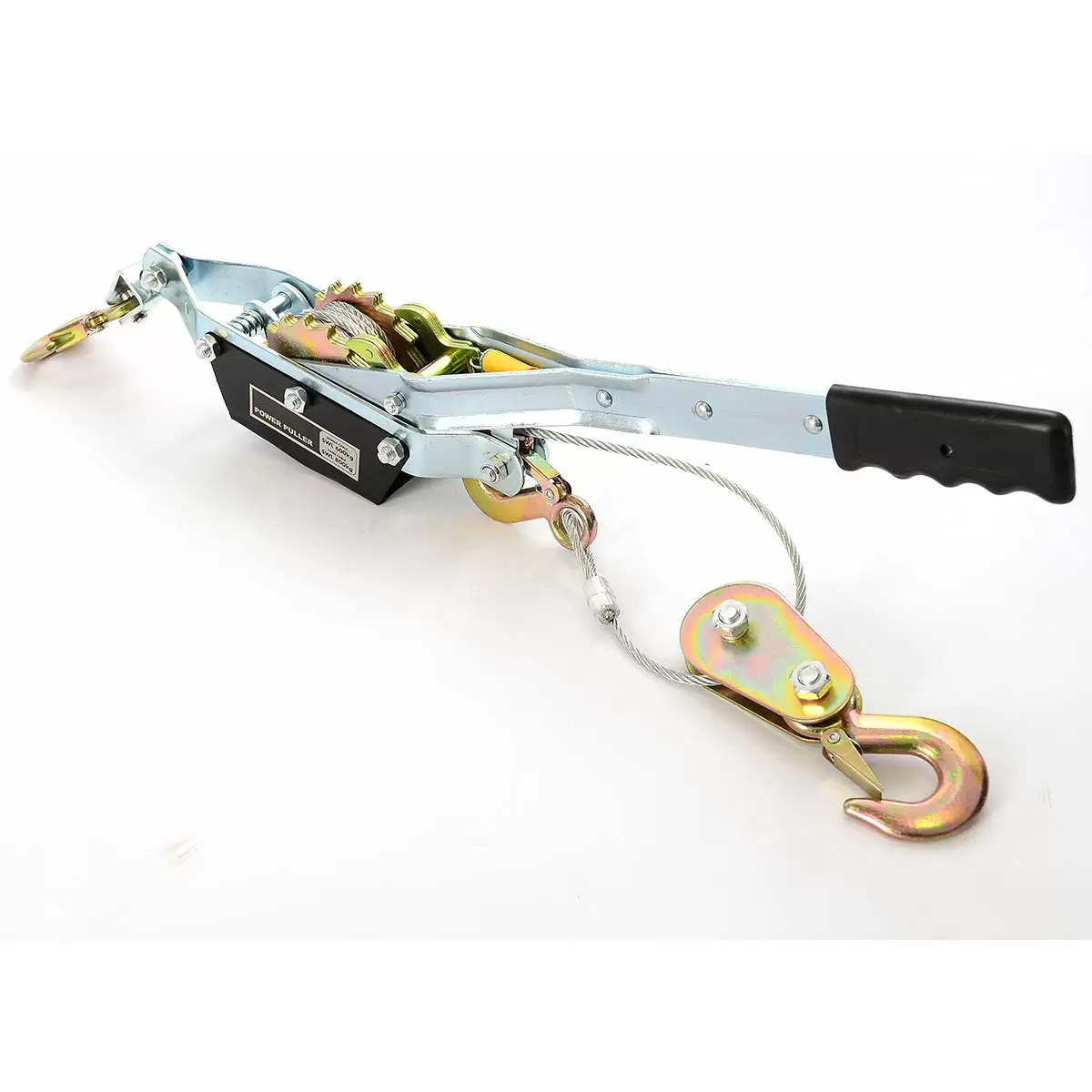 Heavy-duty steel Hilka Pro-Craft 800KG twin-ratchet power puller laying on grass next to an off-road vehicle tyre, showcasing its thick braided steel cable and three drop-forged steel hooks.