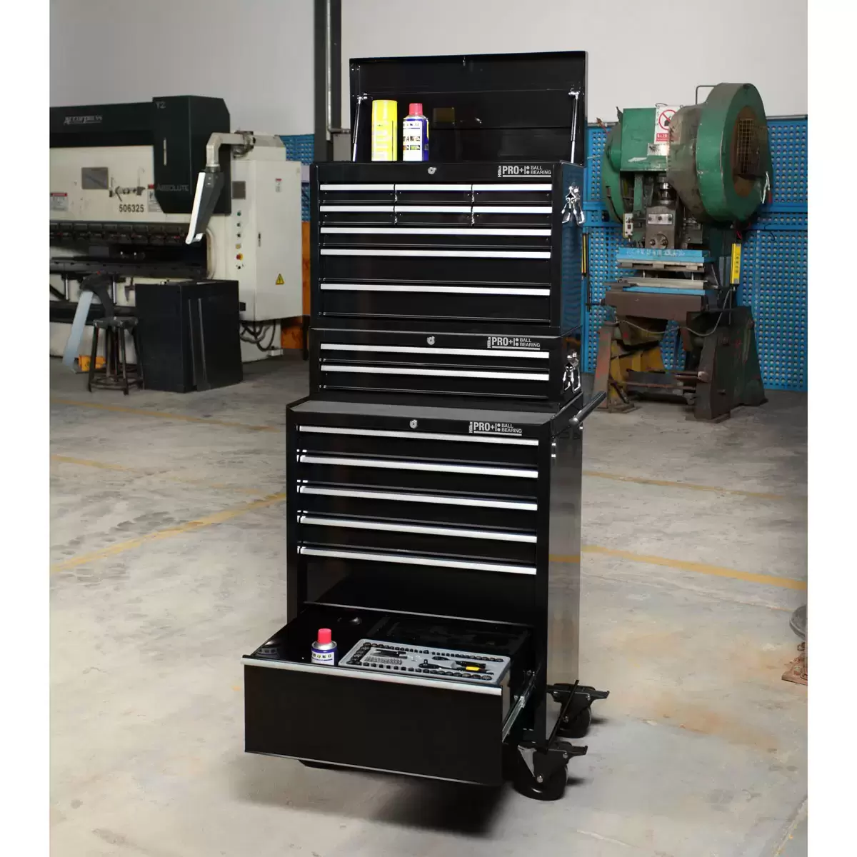 Front angle view of the red steel Hilka HD Pro 17-drawer tool chest trolley combination with opened aluminum pull drawers and heavy-duty castors.