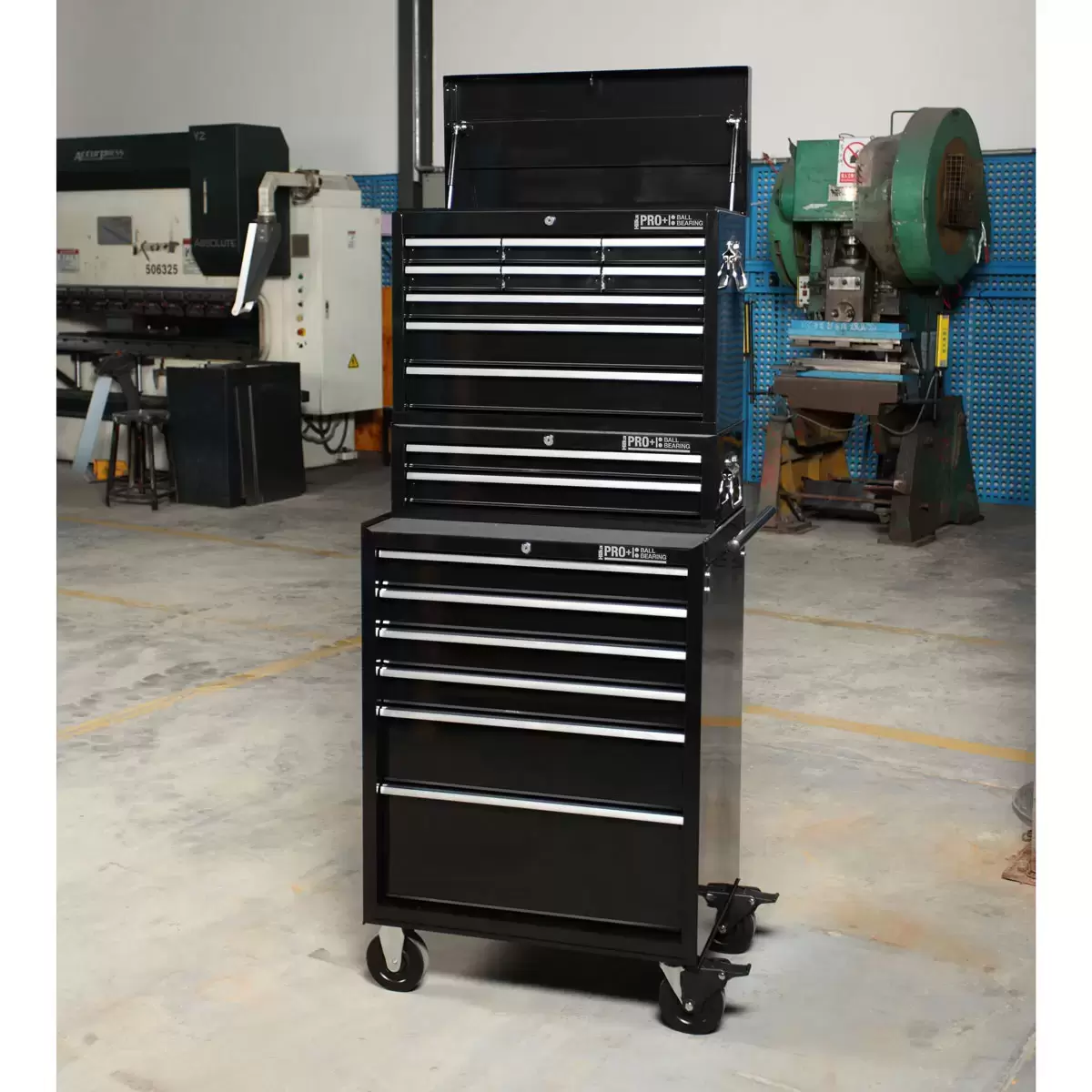 Front angle view of the red steel Hilka HD Pro 17-drawer tool chest trolley combination with opened aluminum pull drawers and heavy-duty castors.