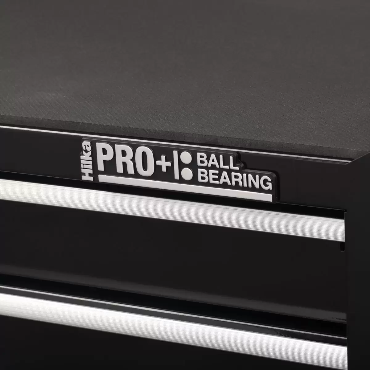 Front angle view of the red steel Hilka HD Pro 17-drawer tool chest trolley combination with opened aluminum pull drawers and heavy-duty castors.