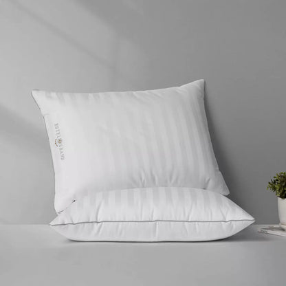 Hotel Grand Feather & Down Rolled Pillow 2 pack styled elegantly on a crisp white bed with silver piping details