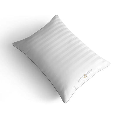 Hotel Grand Feather & Down Rolled Pillow 2 pack styled elegantly on a crisp white bed with silver piping details