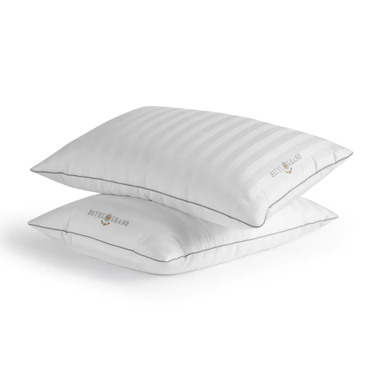 Hotel Grand Feather & Down Rolled Pillow 2 pack styled elegantly on a crisp white bed with silver piping details