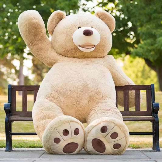 Hugfun 93-inch giant plush sitting teddy bear in soft tan fabric resting upright in a spacious living room.