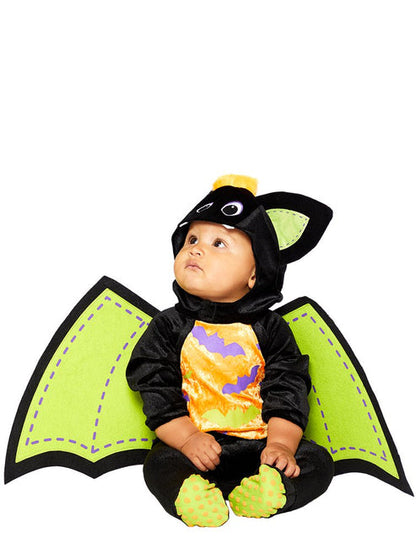 Baby wearing a plush black velvet bat romper with a bat-face hood and attached colorful felt wings in a playroom setting.