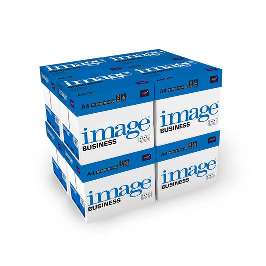 A neat stack of eight cardboard boxes containing Image Business A4 80gsm white printer paper, stacked neatly on a wooden floor in a bright corporate office setting.