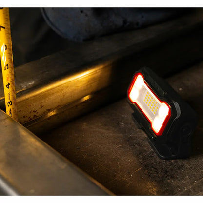 Three compact black and orange Infinity X1 rechargeable work lights displayed showing the 180-degree magnetic base, rear USB-C ports, and hanging clip.