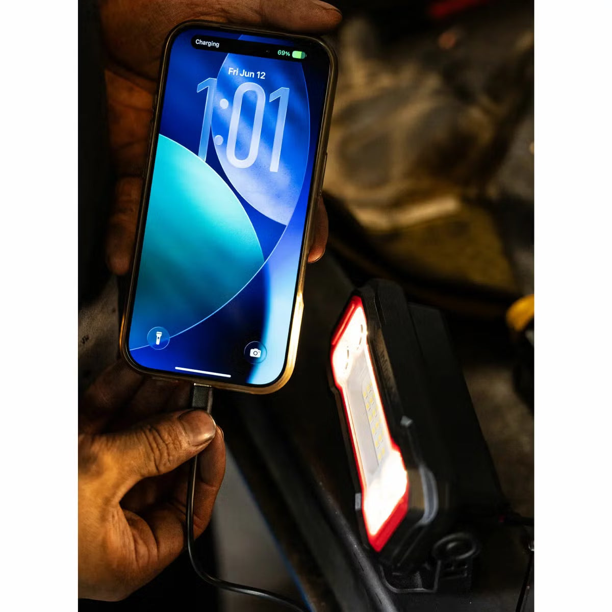 Three compact black and orange Infinity X1 rechargeable work lights displayed showing the 180-degree magnetic base, rear USB-C ports, and hanging clip.