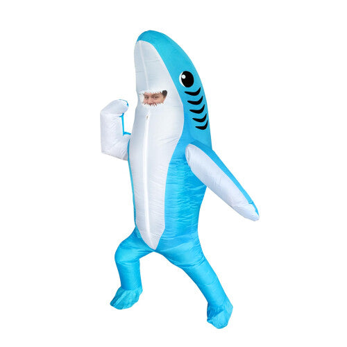 Front view of a full-body bright blue inflated adult shark costume with open jaws and white teeth standing in a party setting.