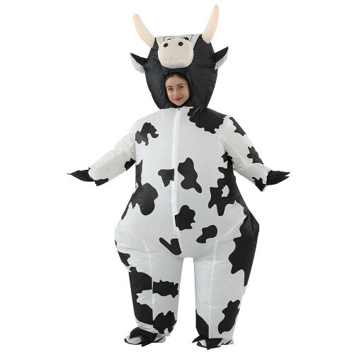 Front view of a fully inflated black and white spot adult cow costume with a cartoon face on a plain background