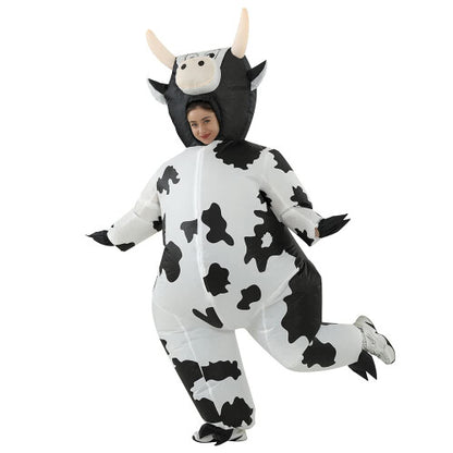 Front view of a fully inflated black and white spot adult cow costume with a cartoon face on a plain background