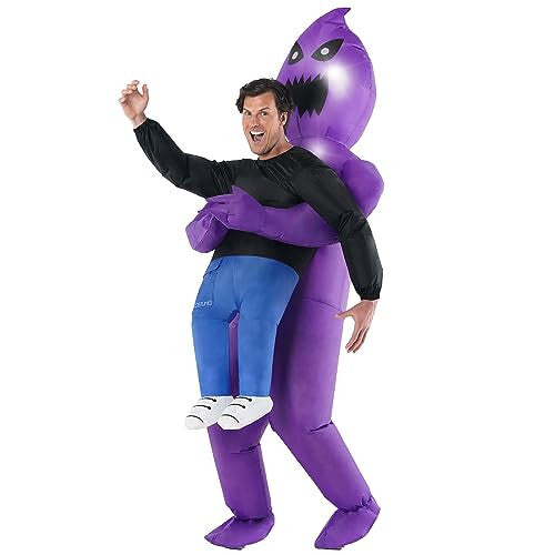 Front view of an adult wearing a purple inflatable carrying ghoul costume with an illuminated LED face glowing in a dimly lit setting.