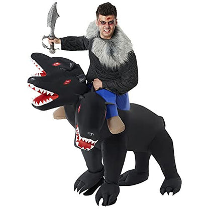 Full-length front view of an adult wearing an inflated brown three-headed Cerberus dog ride-on costume indoors with realistic black leg accents.
