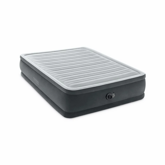 Intex King Dura-Beam Deluxe elevated grey king-size air mattress with plush velvet top and built-in electric pump set up in a bright guest bedroom.
