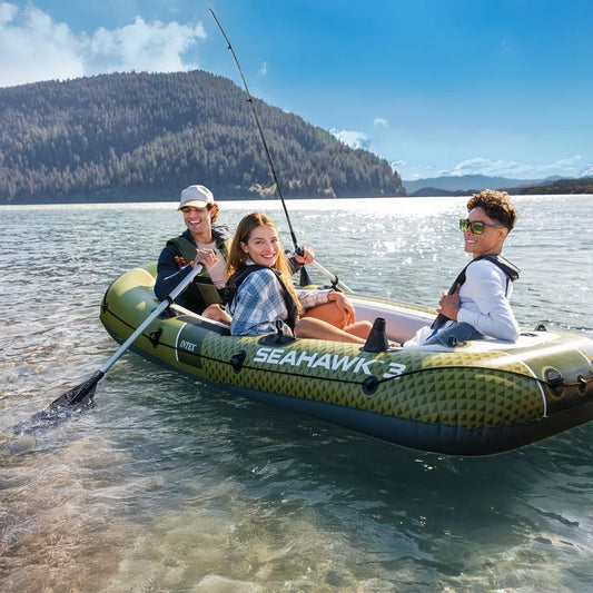 Intex Seahawk 3-person inflatable boat set with oars and pump on a calm lake.