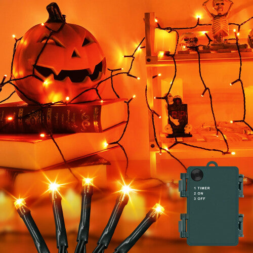 A 3-meter strand of 30 orange LED fairy lights glowing warmly on a green wire wrapped around an outdoor garden tree branch.