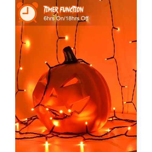A 3-meter strand of 30 orange LED fairy lights glowing warmly on a green wire wrapped around an outdoor garden tree branch.
