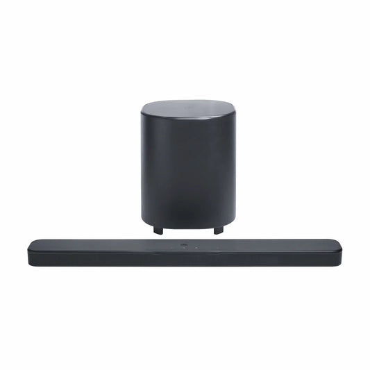 JBL BAR 500MK2 black 5.1 channel soundbar mounted under a wall-mounted TV with its 10-inch wireless subwoofer positioned on a hard-wood floor.