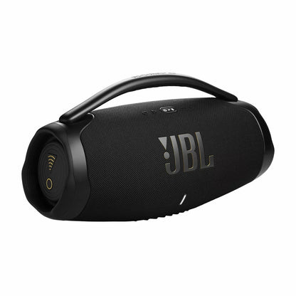 JBL Boombox 3 black Wi-Fi Bluetooth speaker featuring a sturdy metal carrying handle resting on an outdoor table next to a smartphone.