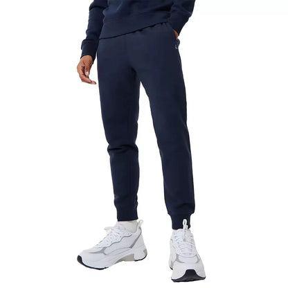 Front view of navy blue Jack Wills Men's Haydor slim fit joggers featuring soft brushed fleece texture, side pockets, and embroidered heritage logo against a clean studio background.
