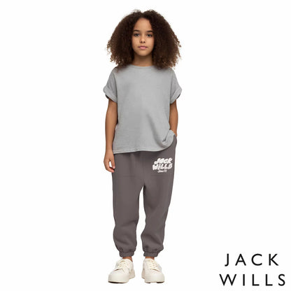 Front view of the Jack Wills Youth Jogger in navy blue, showcasing the tapered leg cut, elasticated cuffs, and jacquard brand logo detail.