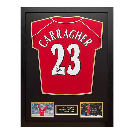 A professionally framed 2000 retro Liverpool football shirt hand-signed by Jamie Carragher, displayed in a dark-wood frame against a neutral wall.