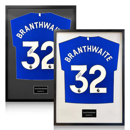 A professionally framed Everton football shirt signed by Jarrad Branthwaite, displayed with a choice of black or white mounting against a neutral gallery background.
