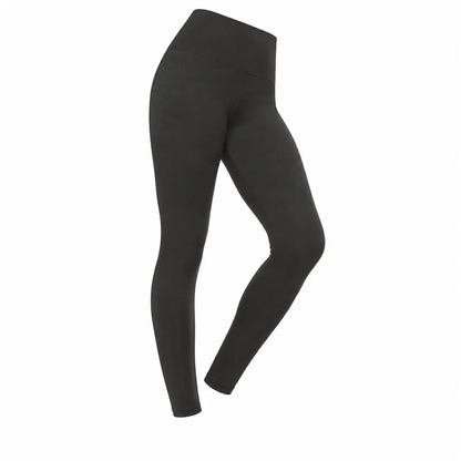 Folded pair of Jezebel velvety black leggings on a wooden surface showing the soft peached fabric texture and wide high-rise waistband.
