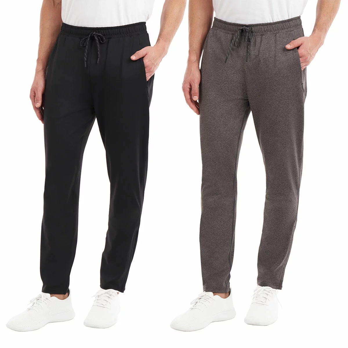 Front view of a man wearing black KS Men's Active Pants with tapered zipped cuffs and an adjustable drawstring waistband.