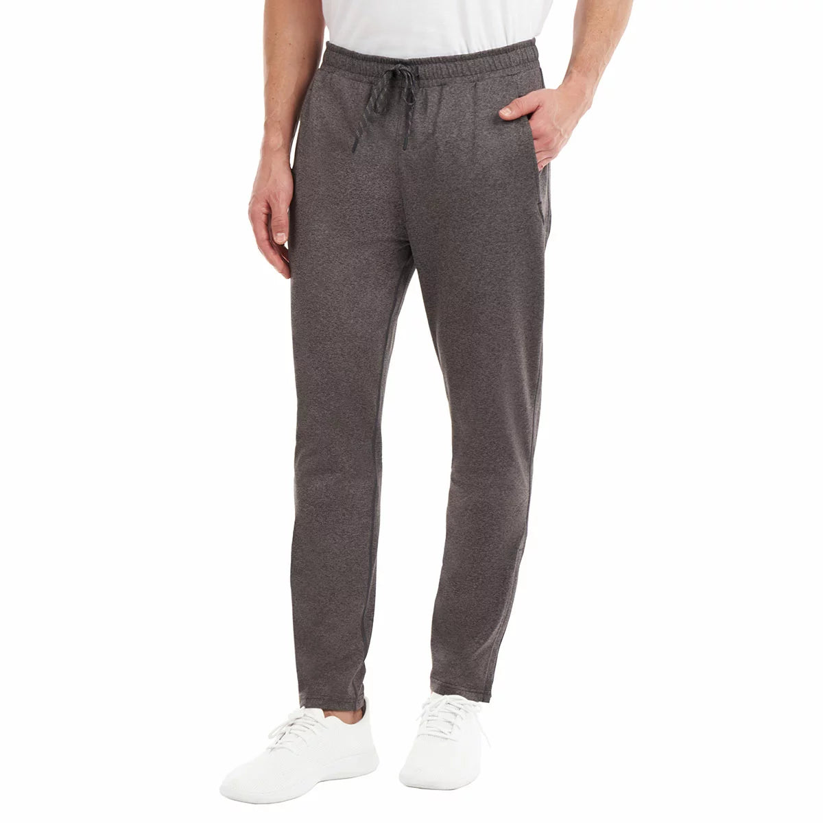 Front view of a man wearing black KS Men's Active Pants with tapered zipped cuffs and an adjustable drawstring waistband.