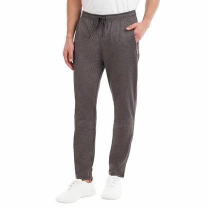 Front view of a man wearing black KS Men's Active Pants with tapered zipped cuffs and an adjustable drawstring waistband.