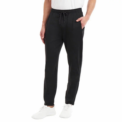 KS Men's Active Pant with stretch performance fabric andFront view of a man wearing black KS Men's Active Pants with tapered zipped cuffs and an adjustable drawstring waistband. breathable athletic casual design/2
