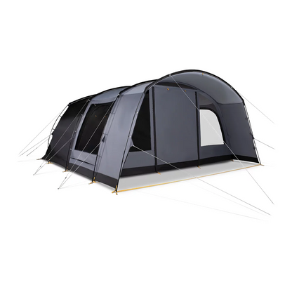 A green and grey Kampa Dawlish 4 Person Tunnel Tent pitched on a lush green grass campsite with its large side door open revealing the darkened inner sleeping compartment.