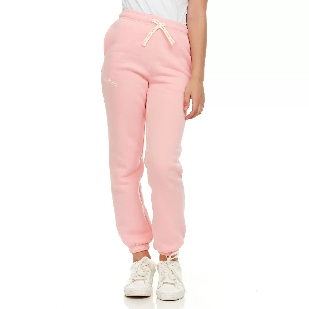 Front view of Keith Haring youth fleece joggers in green showing iconic pop art graphics, side pockets, and an elastic drawstring waistband.