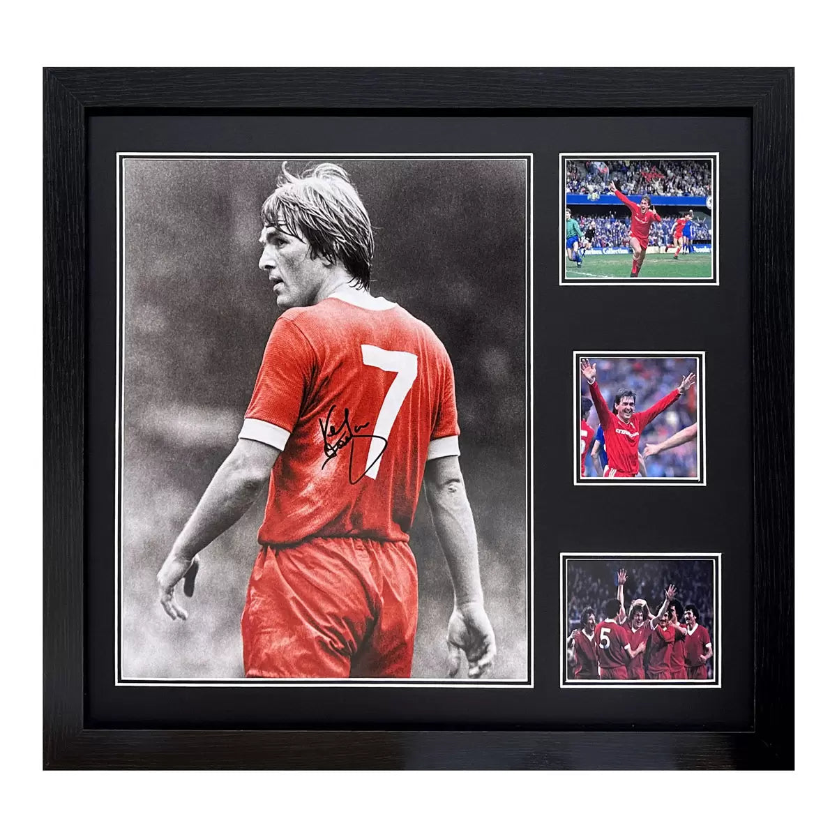 A framed, authentic photograph of Kenny Dalglish in his Liverpool kit, set in a professional black display frame against a clean background.