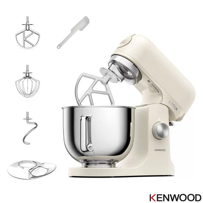 The cream Kenwood kMix KMX751ACR stand mixer shown with its 5L stainless steel bowl, K-beater, and splashguard on a bright kitchen work surface.