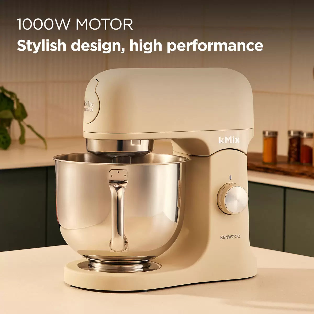 The cream Kenwood kMix KMX751ACR stand mixer shown with its 5L stainless steel bowl, K-beater, and splashguard on a bright kitchen work surface.
