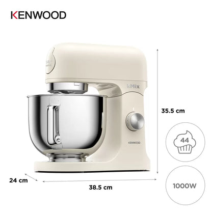 The cream Kenwood kMix KMX751ACR stand mixer shown with its 5L stainless steel bowl, K-beater, and splashguard on a bright kitchen work surface.