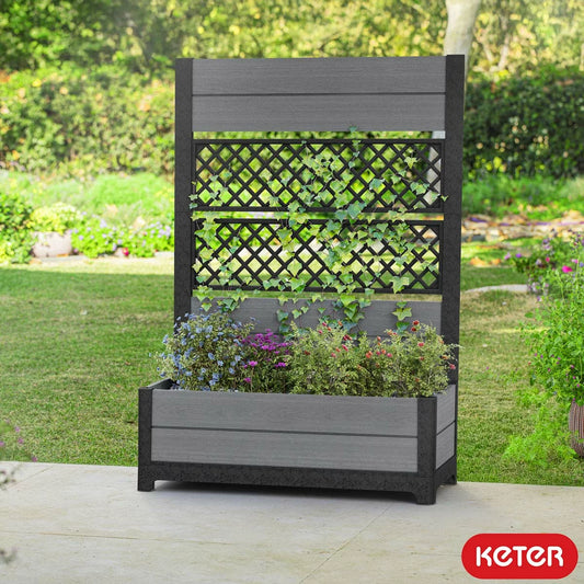Keter Cortina privacy screen with decorative tulip patterns and integrated grey planter box positioned on a modern outdoor patio.