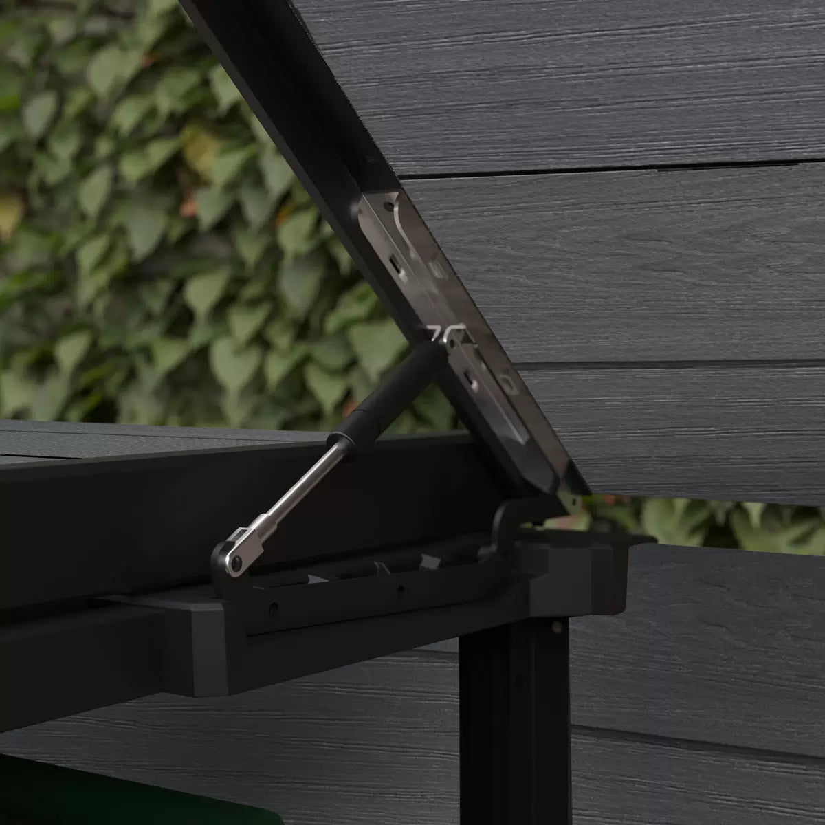 Keter Cortina Hideaway 2-section bin store in a charcoal and wood-grain finish, sitting on a modern patio with two wheelie bins inside.