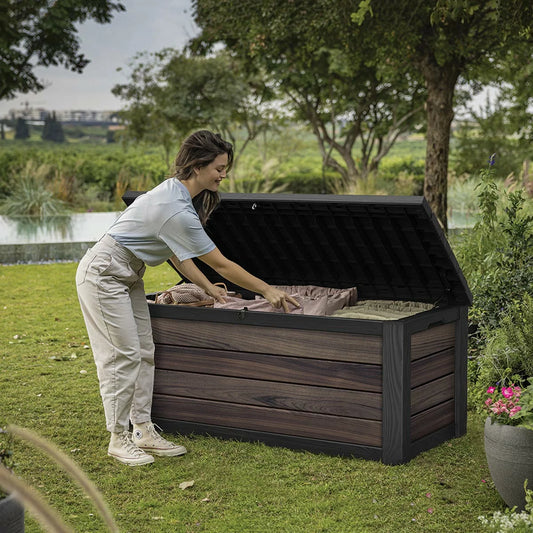 Keter Rosewood Signature 575L deck box standing on a patio, featuring a realistic wood-look finish and secure lid.